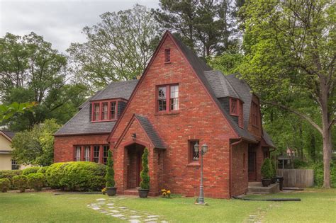 brick houses with red metal roofs|black shingles on brick house.